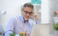 Man working with laptop in home office sitting at desk Royalty Free Stock Photo