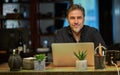 Man working with laptop in home office sitting at desk Royalty Free Stock Photo