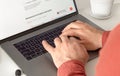 Man working on laptop in office Male hands typing text on the keyboard close up Remote work at home concept Royalty Free Stock Photo