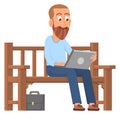 Man working on laptop outdoor. Guy sitting on park bench