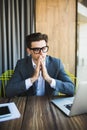 Man working with laptop outdoor. Thinking man with praying hands. Royalty Free Stock Photo