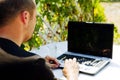 Man working with laptop outside
