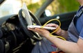 Man working on laptop while sitting in a car in workshop Royalty Free Stock Photo