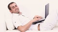 Man working on laptop, sitting on the couch Royalty Free Stock Photo