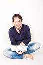 Man working on laptop while sitting on the floor Royalty Free Stock Photo