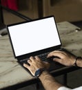 Man working with a laptop with a white screen.