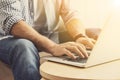 Man working with laptop at wooden table, closeup Royalty Free Stock Photo