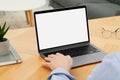 Man working with laptop at wooden table indoors, closeup Royalty Free Stock Photo