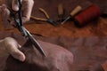 Man working with leather using scissors. Royalty Free Stock Photo