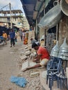 Man working in a local blacksmith`s shop in a local market in Bangladesh during corona to earn his daily living