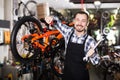 Man working on master mechanic assembling bicycle equipment Royalty Free Stock Photo
