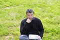 Man working on meadow grass notebook computer Royalty Free Stock Photo