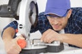 Man working with miter saw closeup Royalty Free Stock Photo