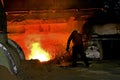 Man working on modern blast furnace casting level. Royalty Free Stock Photo