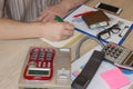 Man working on office desk with Calculator, a computer, a pen and document. Man, counting money and making calculations Royalty Free Stock Photo