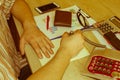 Man working on office desk with Calculator, a computer, a pen and document. Man, counting money and making calculations Royalty Free Stock Photo