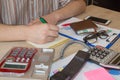 Man working on office desk with Calculator, a computer, a pen and document. Man, counting money and making calculations Royalty Free Stock Photo