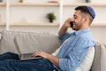 Man working on pc and talking on cellphone at home Royalty Free Stock Photo