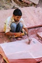 Man working on a piece of sandstone outside Taj Mahal complex in