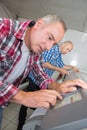 man working in printing house programming printer machine Royalty Free Stock Photo