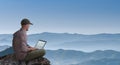 Man working remotely outdoors with laptop Royalty Free Stock Photo