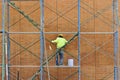 Man working on scaffolding. Royalty Free Stock Photo