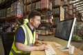 Man working in on-site office at a distribution warehouse