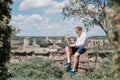 Man working sited on a stone wall Royalty Free Stock Photo