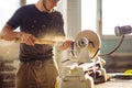 Man working at small wood lathe, an artisan carves piece of wood Royalty Free Stock Photo