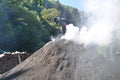 Man working on smoking charcoal-kiln Royalty Free Stock Photo