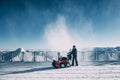 Man working with snow blowing machine in mayrhofen ski area, austria
