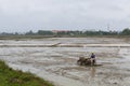 Man is working the soil in mud rice field