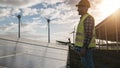 Man working for solar panels and wind turbines - Renewable energy concept - Focus on male worker face