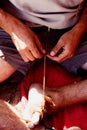 Man working on strings with his hands