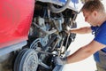 A man is working on a truck engine Royalty Free Stock Photo