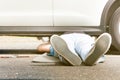 Man working under broken car outside Royalty Free Stock Photo