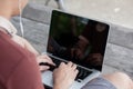 man is working by using a laptop computer on vintage wooden table. Hands typing on a keyboard. Top view. Royalty Free Stock Photo