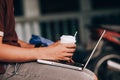 man is working by using a laptop computer on vintage wooden table. Hands typing on a keyboard. Top view. Royalty Free Stock Photo