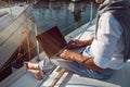 Man is working during the vacation on a sailboat Royalty Free Stock Photo