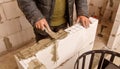 A man is working on a wall, applying a layer of cement Royalty Free Stock Photo