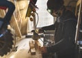 Man working with wood in workshop using sanding machine
