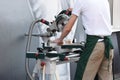 Man working on woodworking machine tool. Carpenter, woodworker using circular saw. Carpenter use circular table electric saw Royalty Free Stock Photo