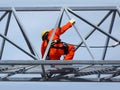 Man Working on the Working at height. Professional industrial climber in helmet and uniform works at height. Risky extreme job. Royalty Free Stock Photo