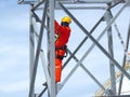 Man Working on the Working at height. Professional industrial climber in helmet and uniform works at height. Risky extreme job. Royalty Free Stock Photo