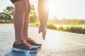 Man workout wellness concept : Runner feet with sneaker shoe running on road in the park. Focus on shoe. Shot in morning time,