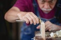 A man works in a carpentry shop. Carpenter working on woodworking machines in carpentry shop Royalty Free Stock Photo