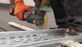 Man works circular saw. Sparks fly from hot metal. Man hard worked over the steel. Male hand cuts off pieces of pipe