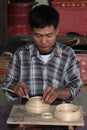 A man works in a factory of lacquerware Royalty Free Stock Photo