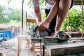 A man works with his hands and a construction tool. Electric saw. Work on wooden boards. To cut the materials. Royalty Free Stock Photo