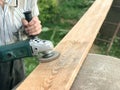 The man works with his hands, grinds the disk around for the grinder, the electric tool for grinding and polishing the surface Royalty Free Stock Photo